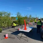 Community members picking up free trees at the Keep Nassau Beautiful tree giveaway event in Yulee